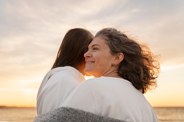 Donne del colpo medio in spiaggia