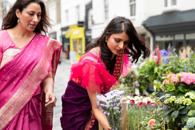 Medium shot women and beautiful flowers