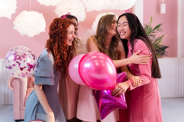Medium shot women celebrating with balloons