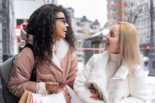 Medium shot women chatting outdoors