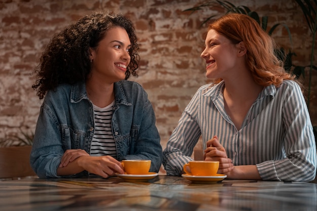 Medium shot women in coffee shop