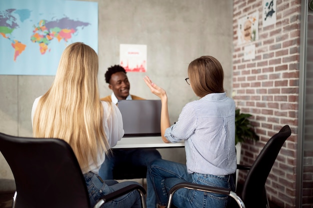 Medium shot women discussing with travel agent