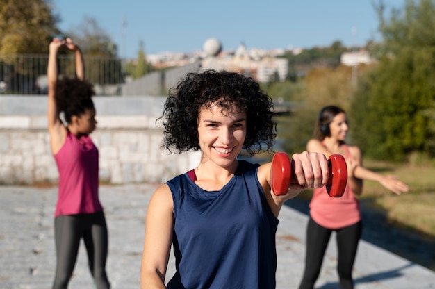 Free photo medium shot women doing sport outdoors