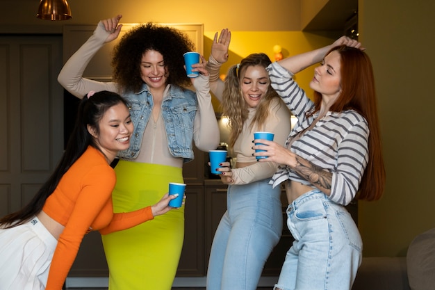 Free photo medium shot women having fun at party