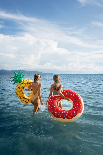 Medium shot women holding floaters