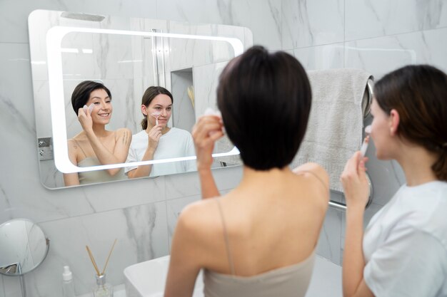 Medium shot women holding gua sha tools