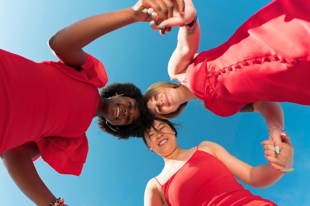 Medium shot women holding hands