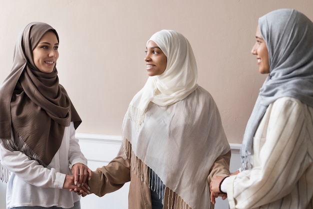 Medium shot women holding hands