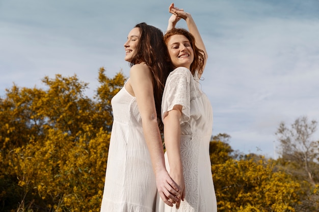 Medium shot women holding hands