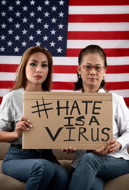 Free photo medium shot women holding placard with message