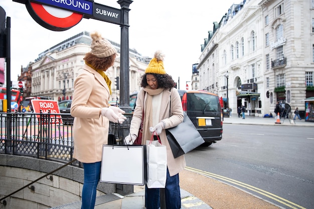 Medium shot women holding shopping bags