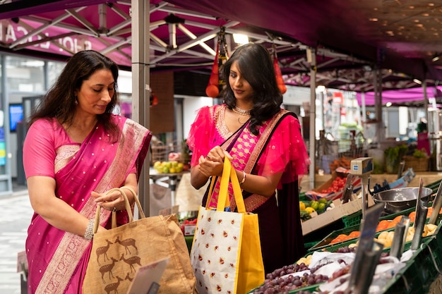 Medium shot women holding shopping bags