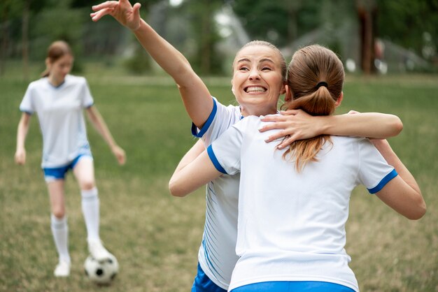 Medium shot women hugging