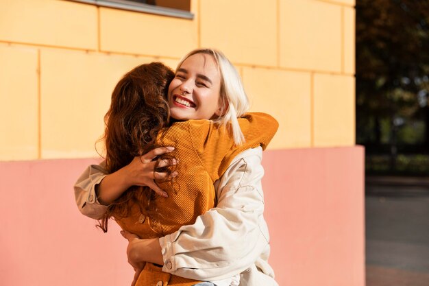 Medium shot women hugging