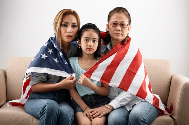 Medium shot women and kid with flag