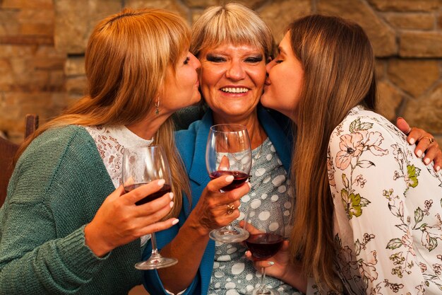 Medium shot women kissing grandma