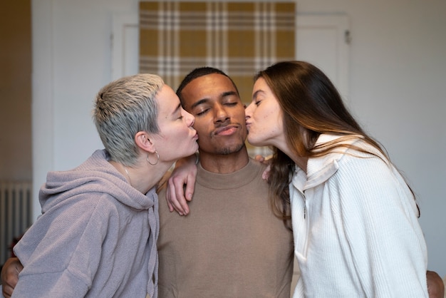 Medium shot women kissing man