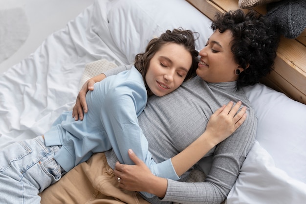 Medium shot women laying in bed