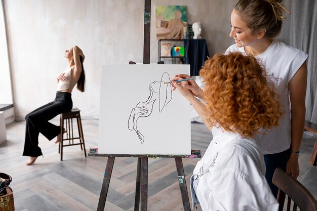Medium shot women painting together