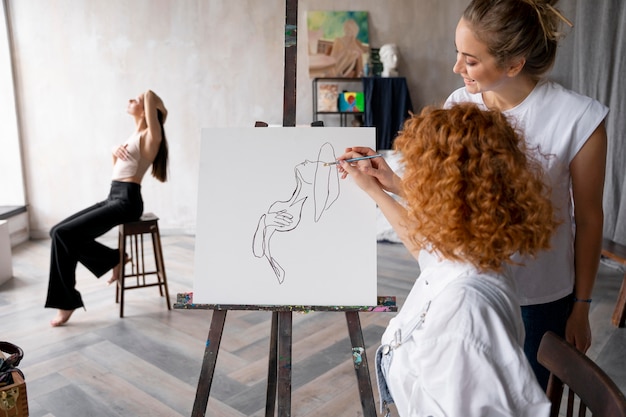 Medium shot women painting together