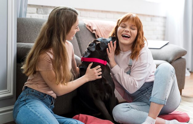 Medium shot women petting dog