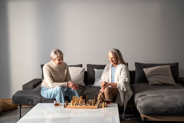 Foto gratuita donne di tiro medio che giocano a scacchi