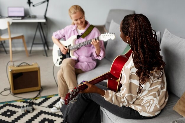 ギターを弾くミディアムショットの女性