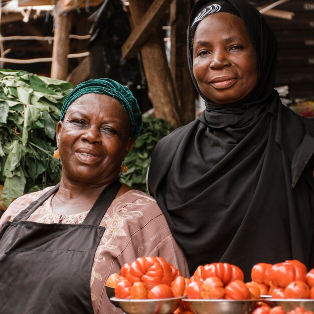 medium shot women posing at market