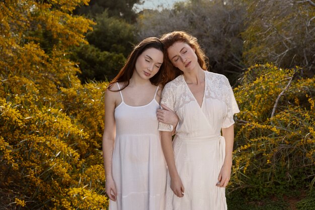 Medium shot women posing outdoors