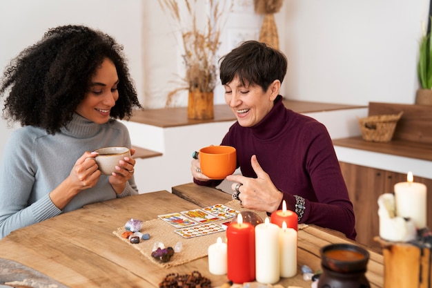 Free photo medium shot women reading tarot