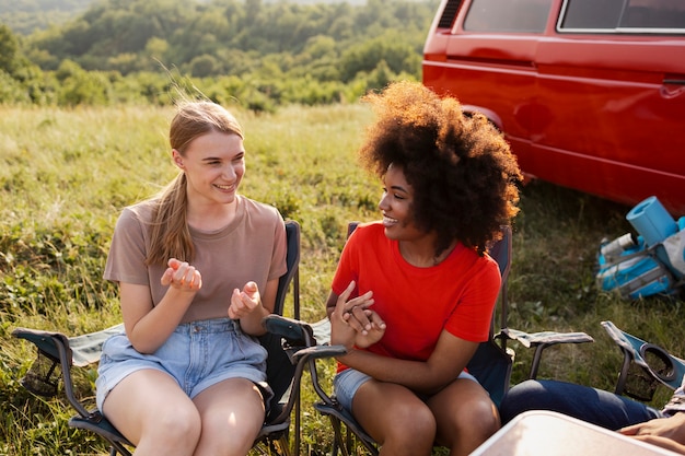 Medium shot women sitting on chairs