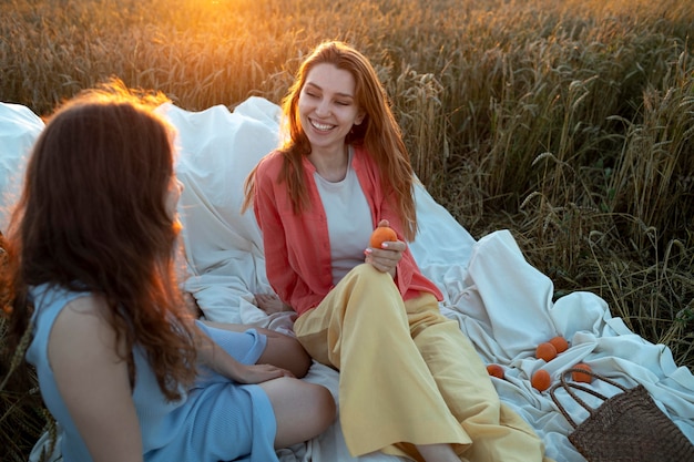 Medium shot women sitting outdoors