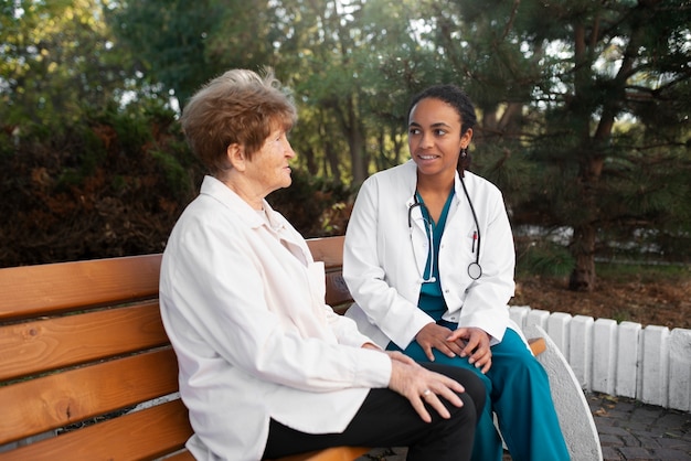 Medium shot women sitting outdoors