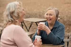 Free photo medium shot women sitting at table