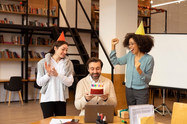 Medium shot women surprising man at office