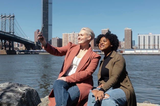 Medium shot women taking selfie