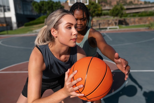 Medium shot women training for basketball