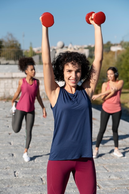 Medium shot women training outdoors