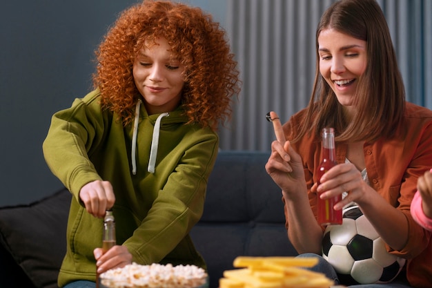 Medium shot women watching sports