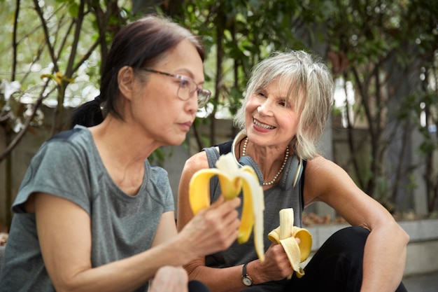 Medium shot women with bananas