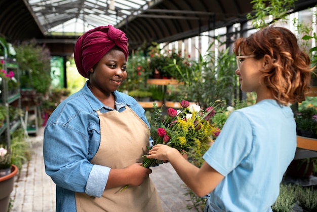 Medium shot women with beautiful flowers