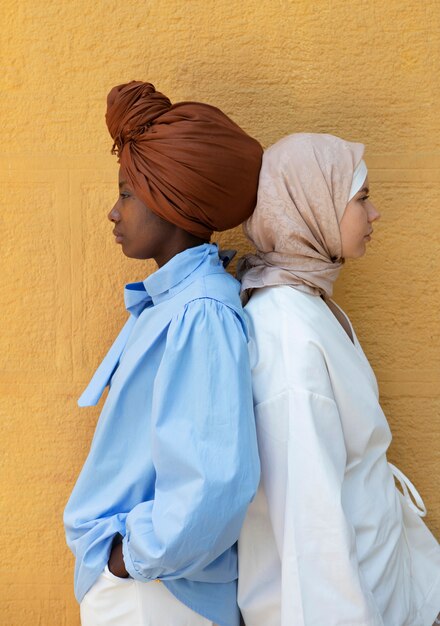 Medium shot women with hijab posing together
