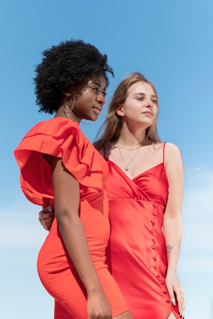 Medium shot women with red dresses