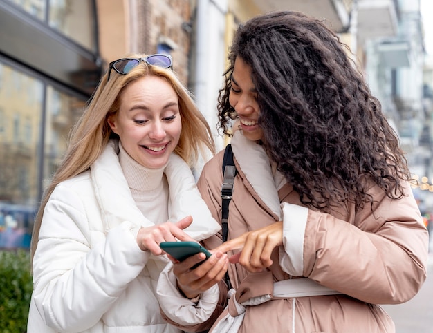 Medium shot women with smartphone