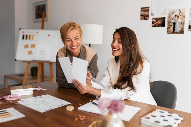 medium shot women working as wedding planners