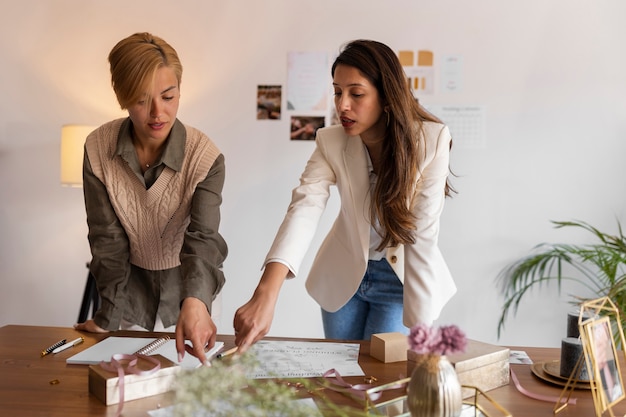 Medium shot women working as wedding planners