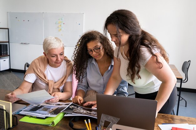 Medium shot women working together