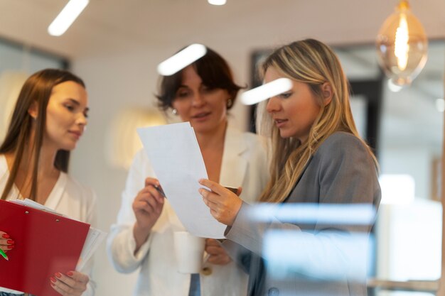 Medium shot women working together