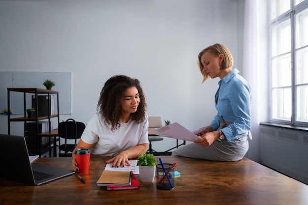 Medium shot women working together