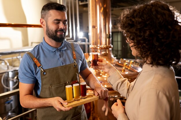 Medium shot working in beer factory